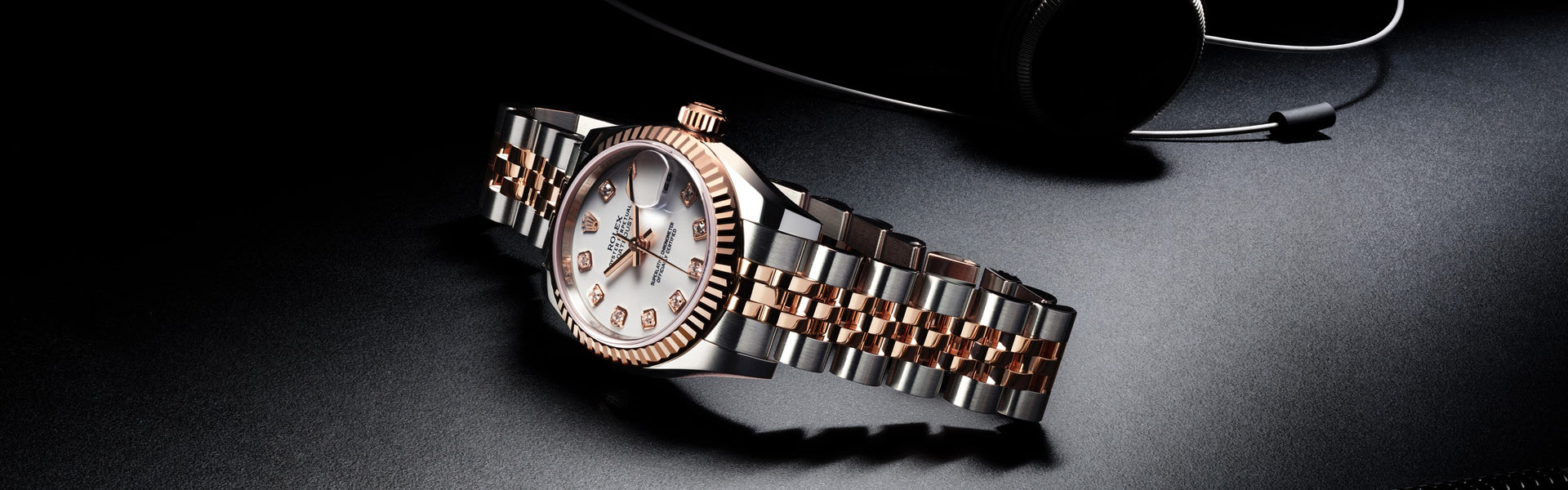 Certified Pre Owned Rolex in White and Rose Gold with White Dial on Black Background