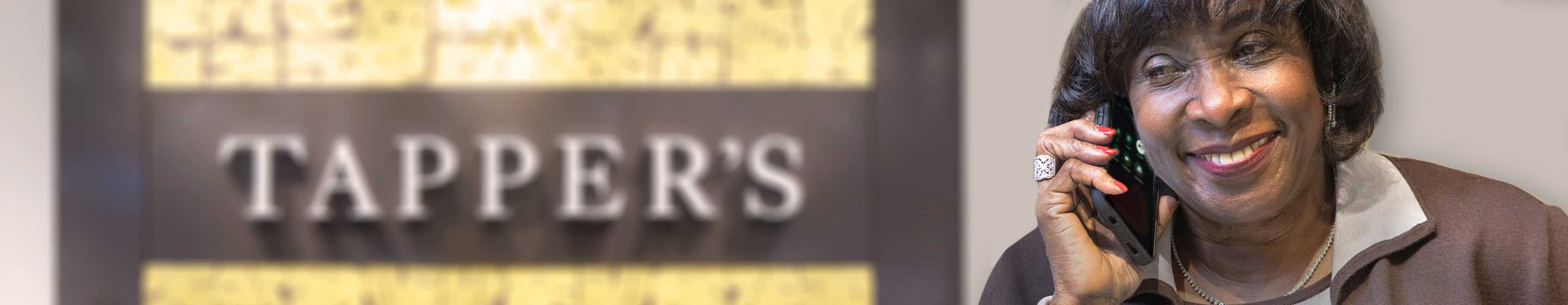 Tapper's Team Member assisting a customer on the phone