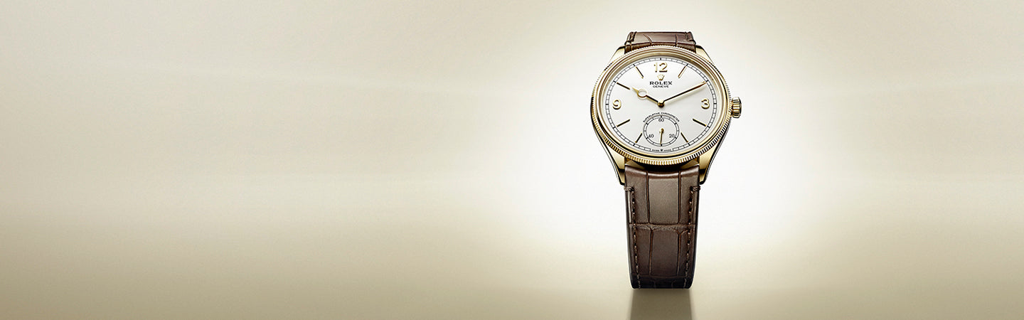 Rolex 1908 Watch with White Face, Gold Case and Brown Strap