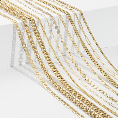 Gold And Estate Buying - Ten different kinds of gold necklaces laying across a white step