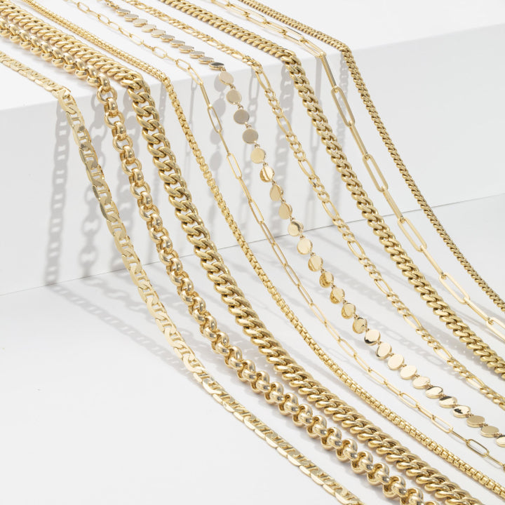 Gold And Estate Buying - Ten different kinds of gold necklaces laying across a white step