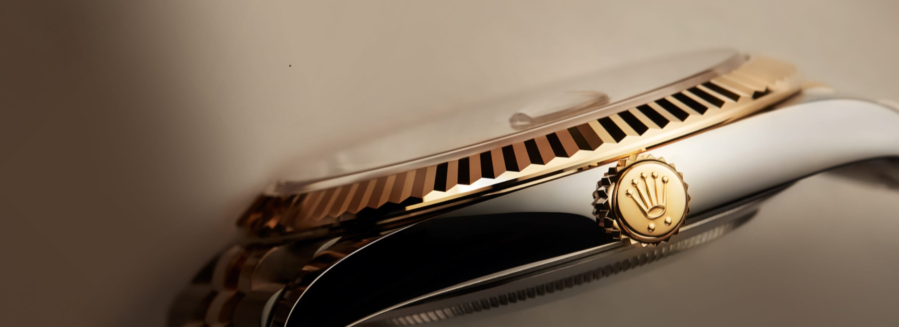 Close-up of a Rolex watch with gold and silver band
